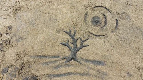 My wife's tree and sky in sand.