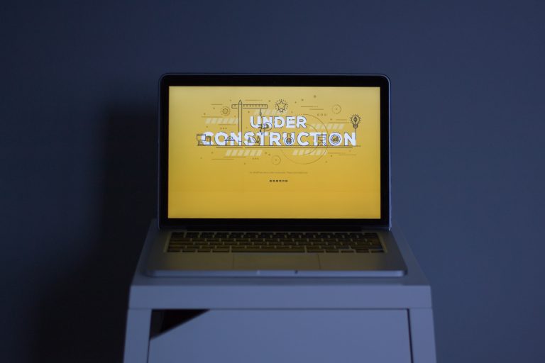 A laptop showing an under-construction page created with a WordPress plugin