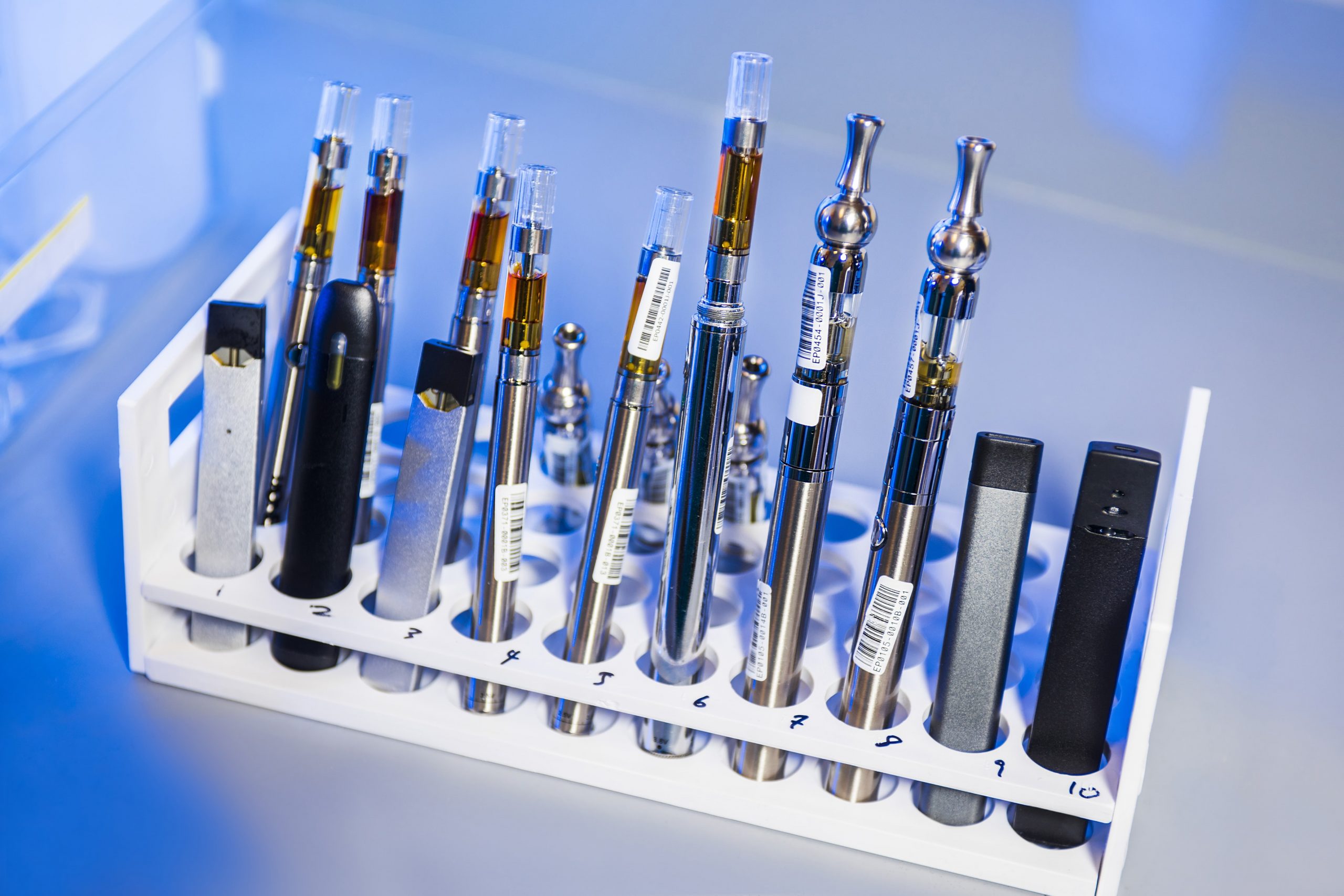 A test tube rack that had been stocked with examples of various electronic cigarettes.