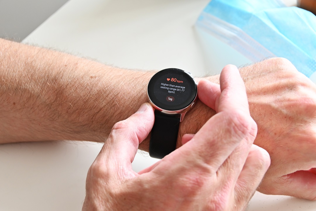 Smart watch displaying heart health metrics on wrist.