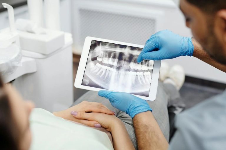 Dentist showing xray to patient