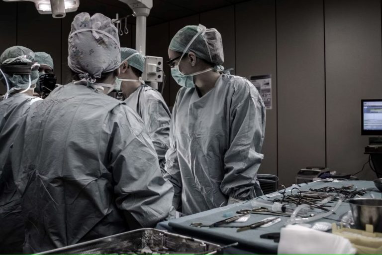 Surgeons standing by during an operation.